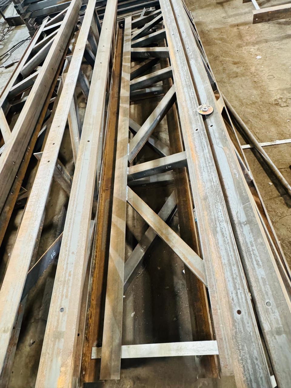 Long fabricated braced steel members prepared in the workshop