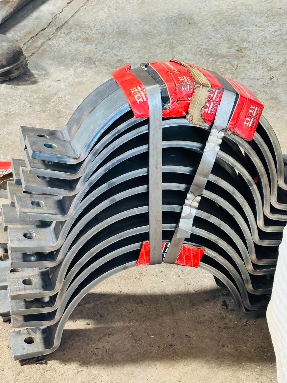 Batch of formed steel brackets with mounting holes